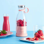 Pink glass bottle with raspberries labeled 'Fresh Juice' on a blue background