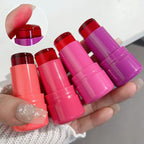 Four lip balm sticks in pink and purple held by a hand with a close-up of a pink lip balm.