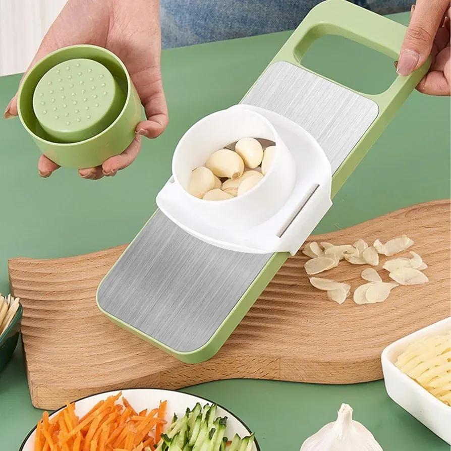 Garlic peeler with garlic on a wooden cutting board, surrounded by vegetables.