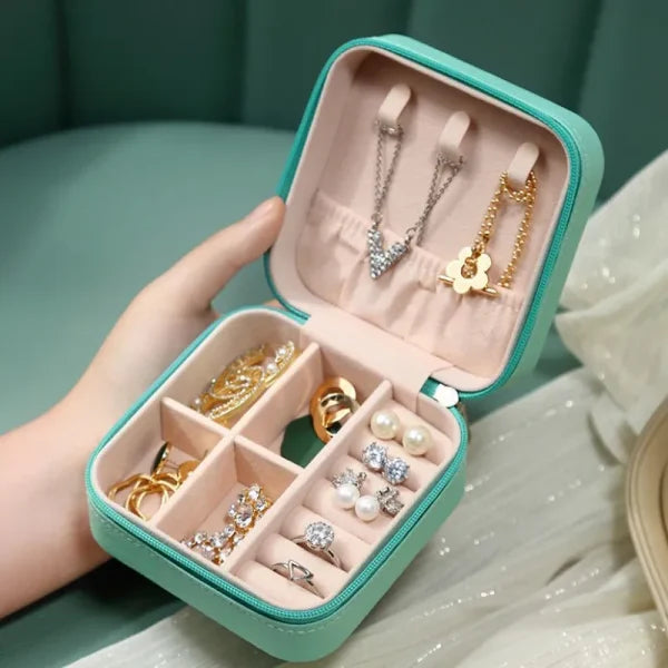 Jewelry box with necklaces, earrings, and rings on a soft surface