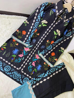 Navy blue scarf with colorful floral and geometric patterns on a white surface