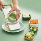Vegetable slicer with sliced vegetables on a green background