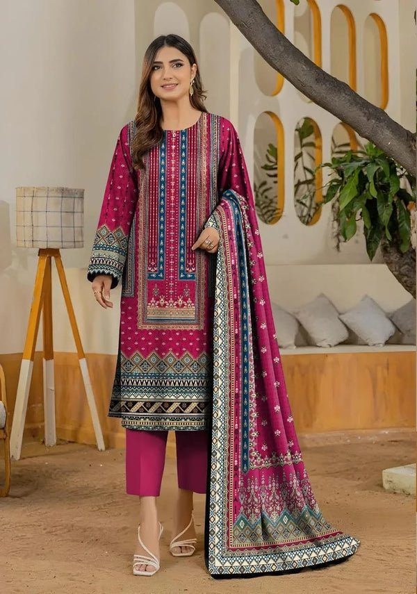 Woman wearing a traditional outfit with a pink and blue patterned dupatta in a home setting.