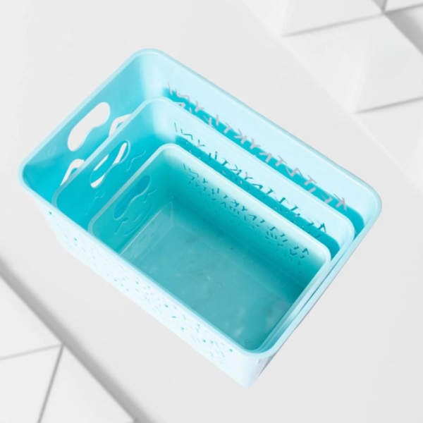 Blue silicone mold with engraved text on a white tiled floor