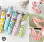 Colorful test tube-shaped containers with cartoon labels on a white background, next to images of hands washing with soap.