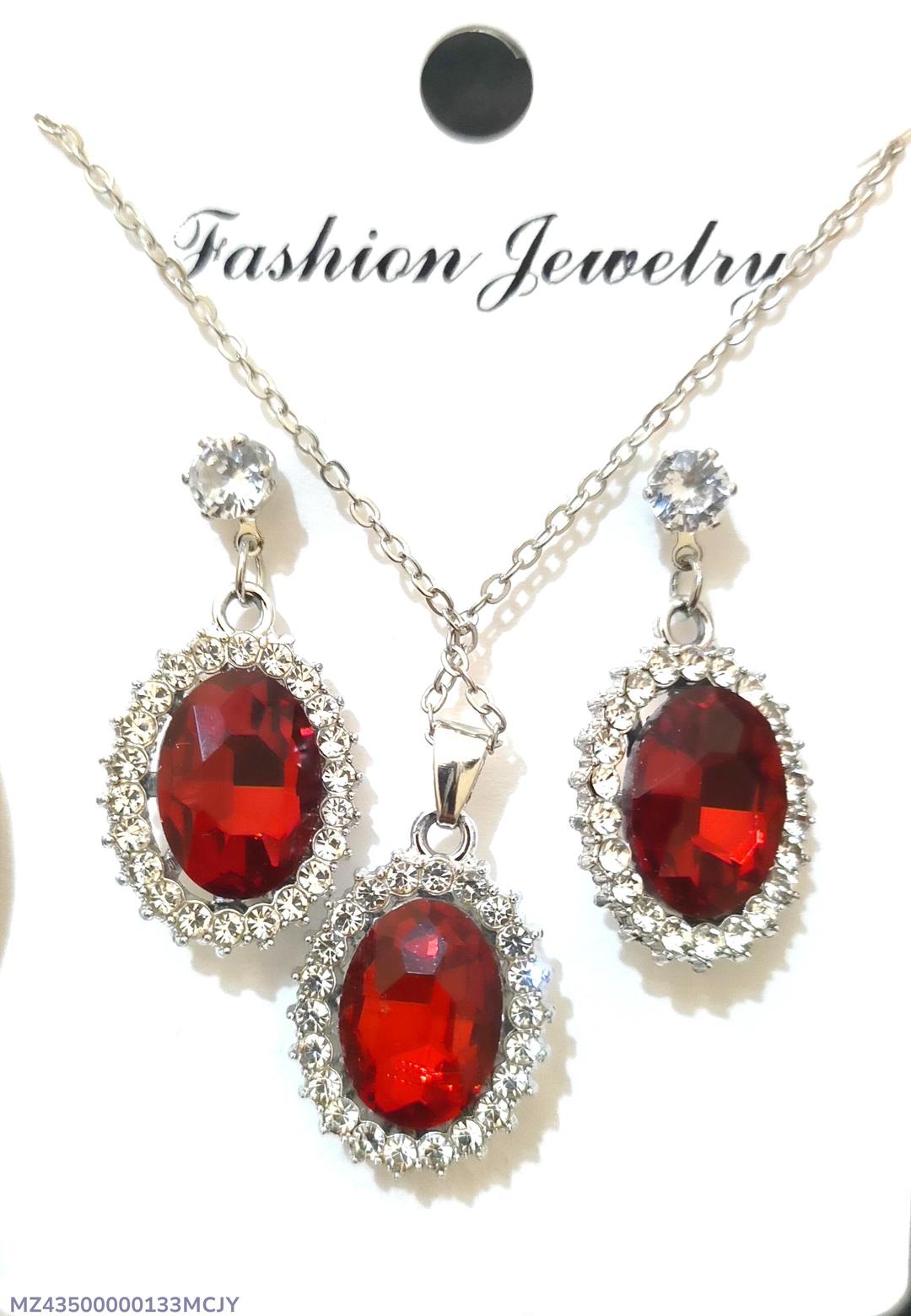 Jewelry set with red gemstones and silver accents on a white background