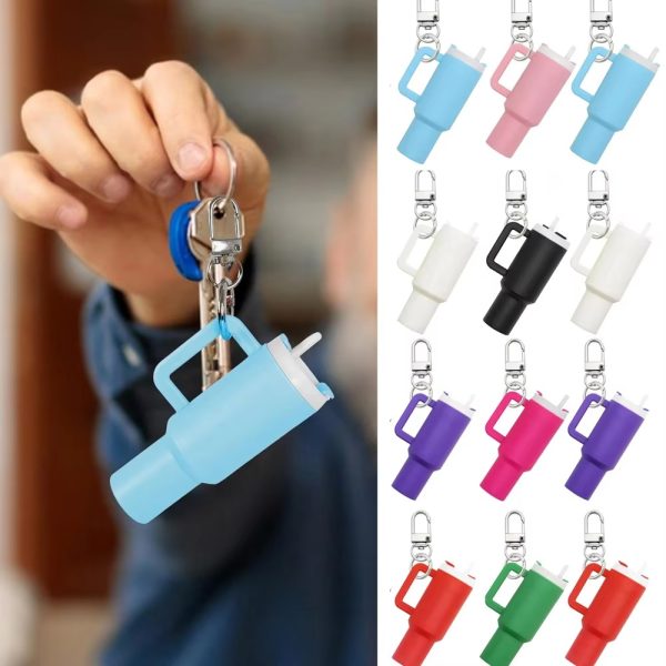 Blue keychain with a holder and colorful keychain holders on a blurred background