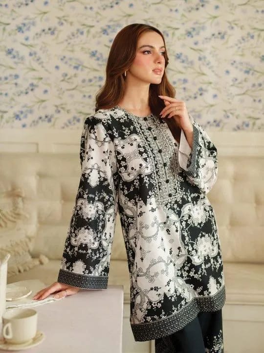 Woman wearing a black and white floral dress in a decorated room.