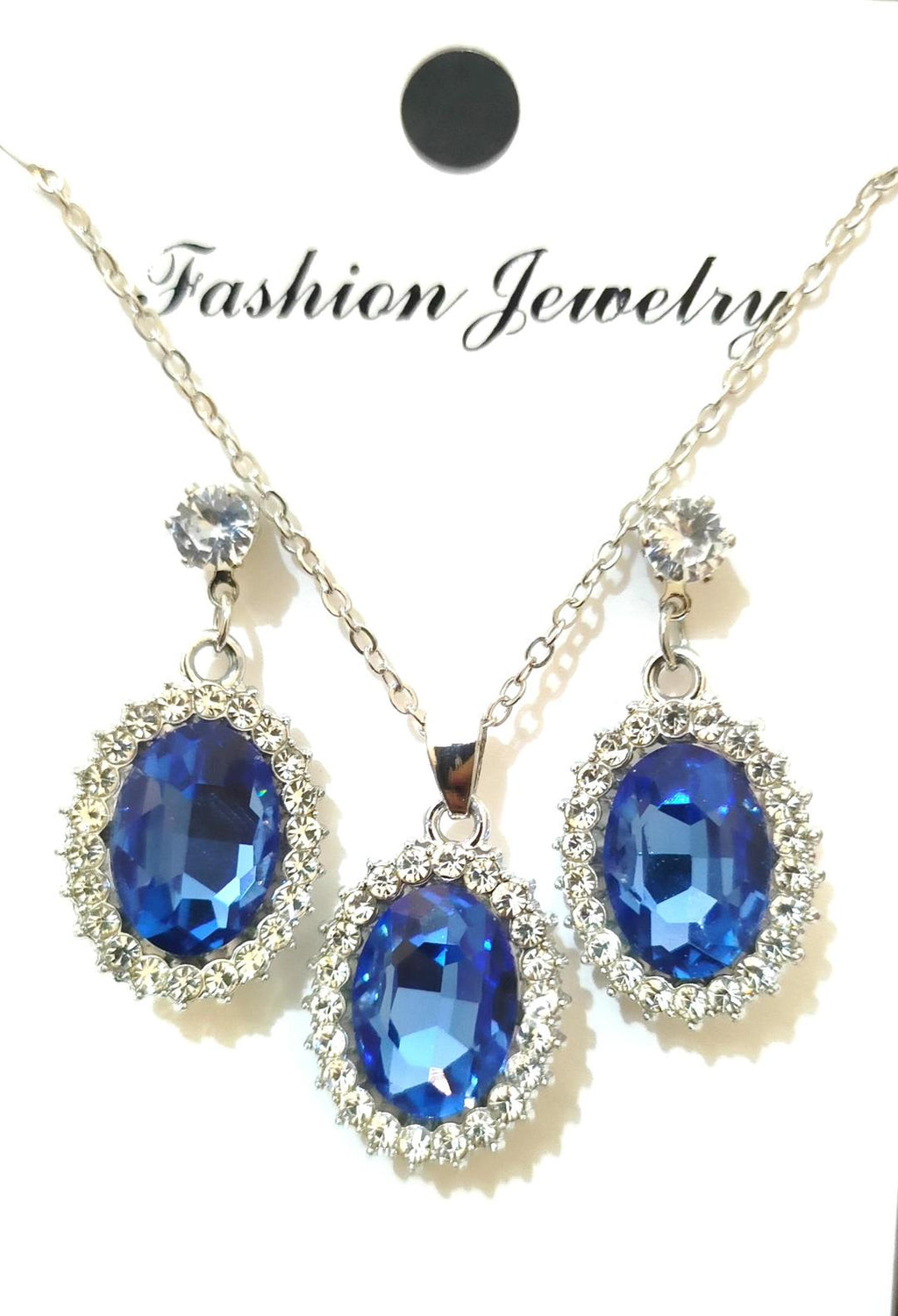 Jewelry set with blue gemstones on a white background