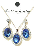 Jewelry set with blue gemstones on a white background
