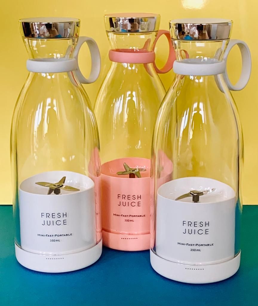 Three transparent bottles with colorful lids and 'Fresh Juice' labels on a blue and yellow gradient background.